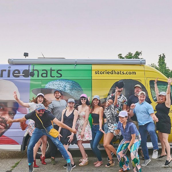 Storied Hats team in front of branded campaign van